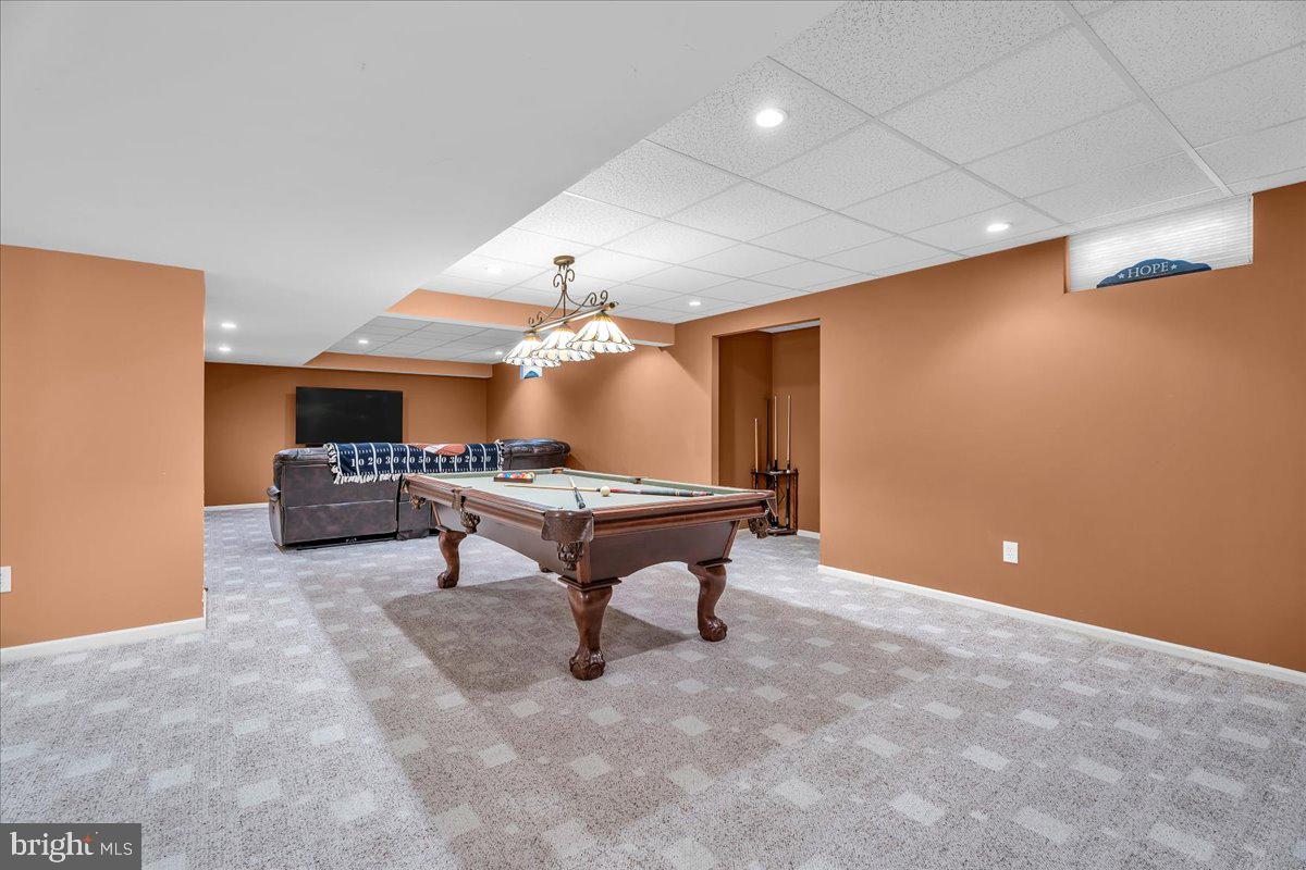 74 Candlewood Road Williamstown, NJ 08094 - Photo 29 of 45 Spacious game room with warm tones.