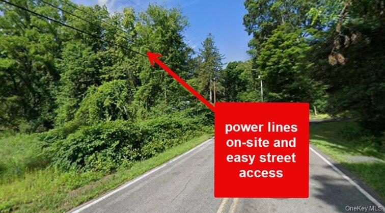 0 Primrose Hill Road Rhinebeck, NY 12572 - Photo 5 of 18 a sign that is sitting on a road near a garden