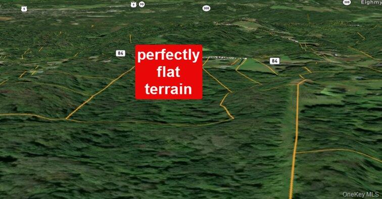 0 Primrose Hill Road Rhinebeck, NY 12572 - Photo 7 of 18 a blue sign that is sitting in the grass next to a wall