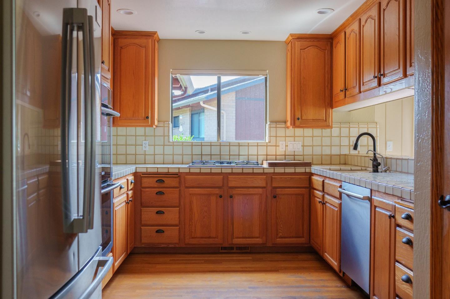 14170 Reservation Road Salinas, CA 93908 - Photo 14 of 22 a kitchen with stainless steel appliances granite countertop a sink stove and refrigerator