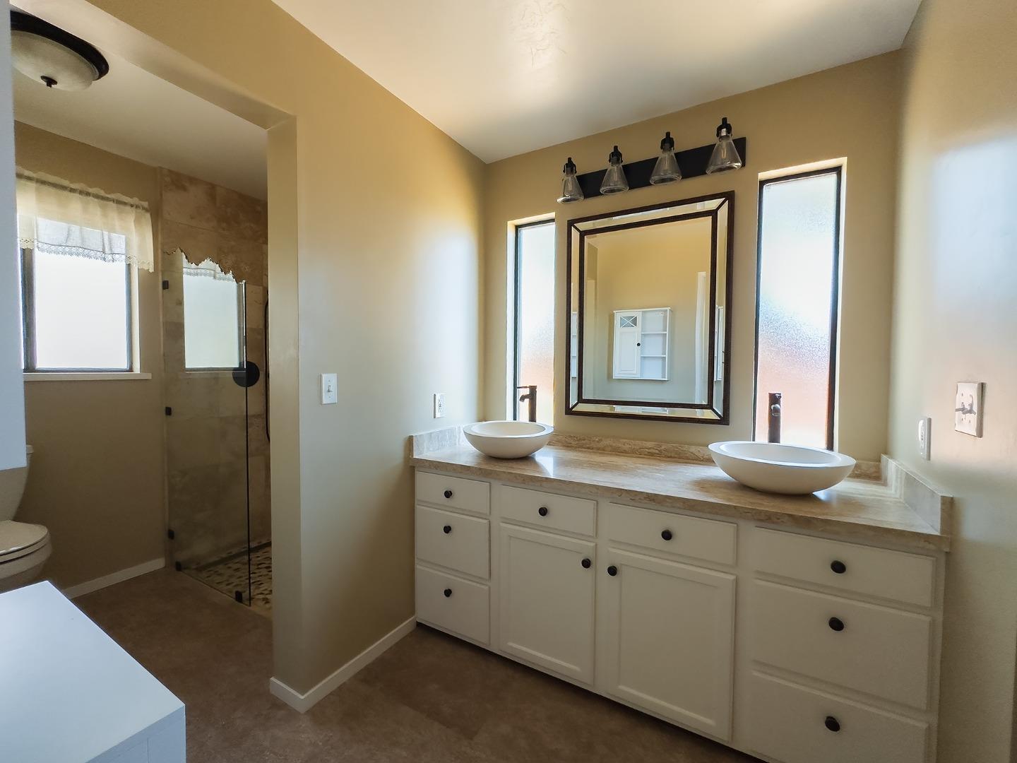 14170 Reservation Road Salinas, CA 93908 - Photo 16 of 22 a bathroom with a sink mirror and a toilet
