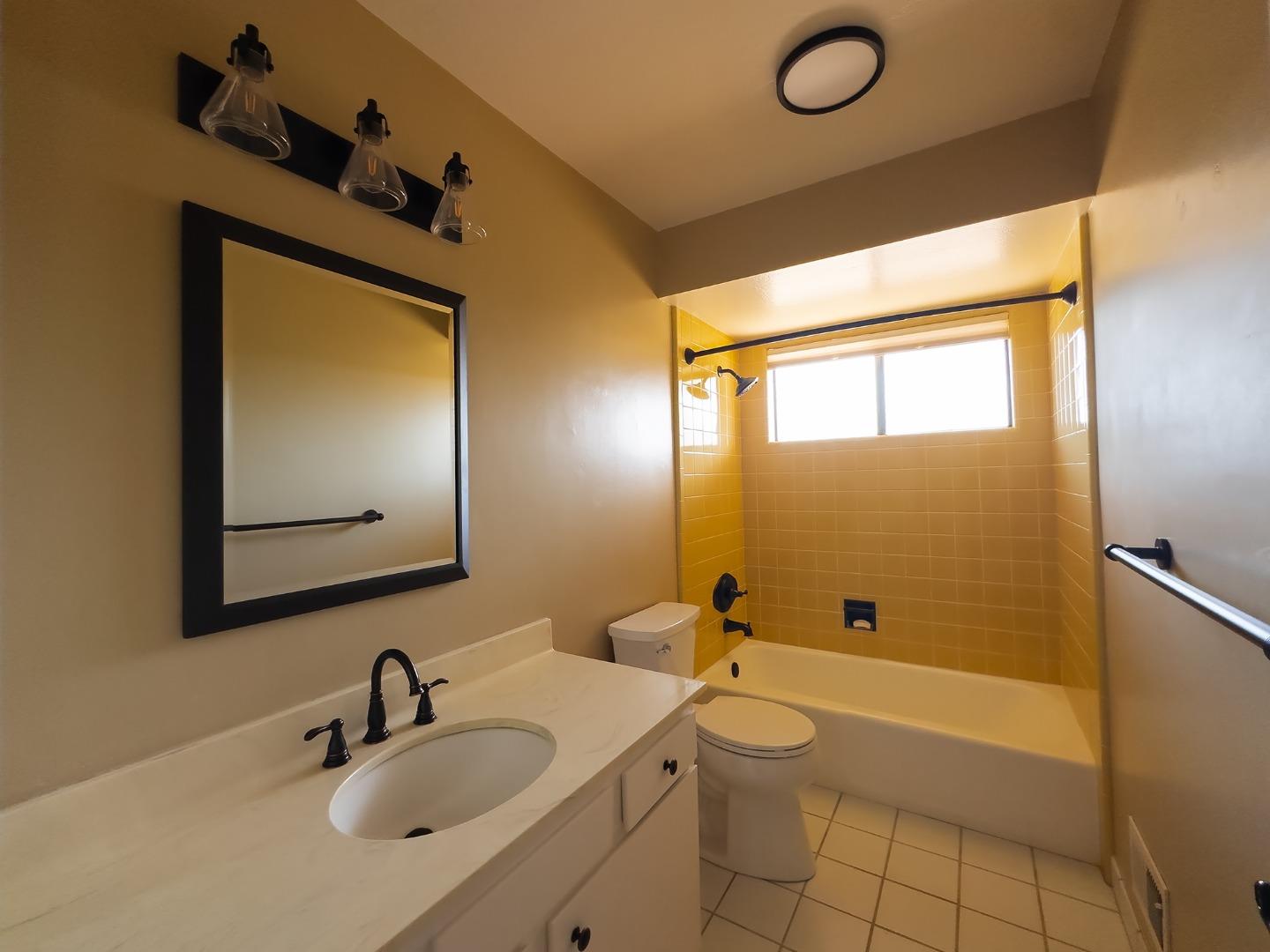 14170 Reservation Road Salinas, CA 93908 - Photo 20 of 22 a bathroom with a toilet a sink and bathtub