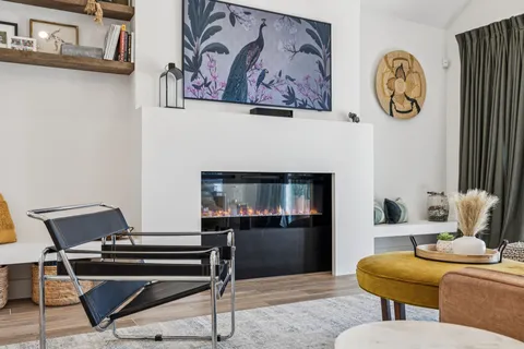 a living room with furniture a rug and a table