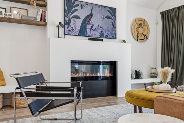 a living room with furniture a rug and a table