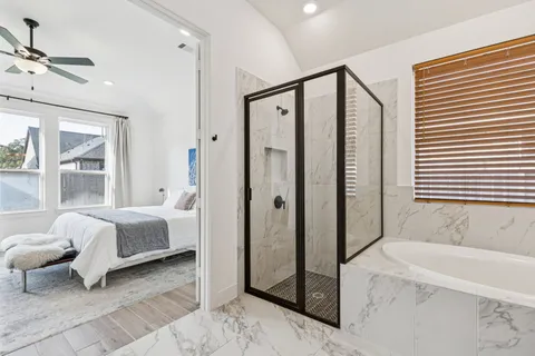 a bathroom with a bathtub sink and mirror