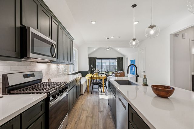 a kitchen with a sink a stove and a refrigerator