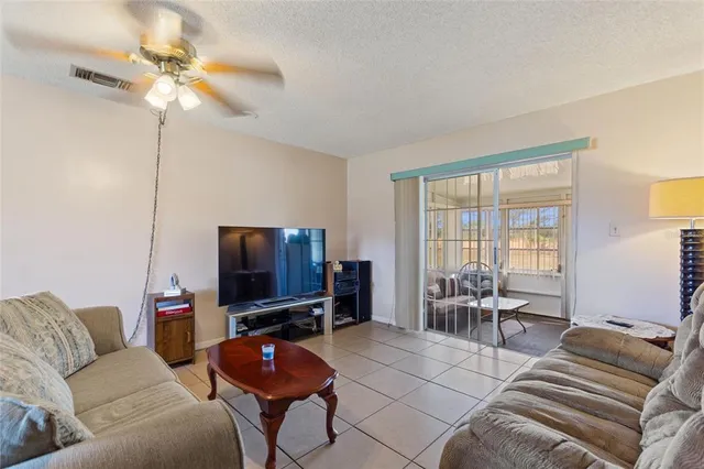 a view of a dining room with furniture and a chandelier