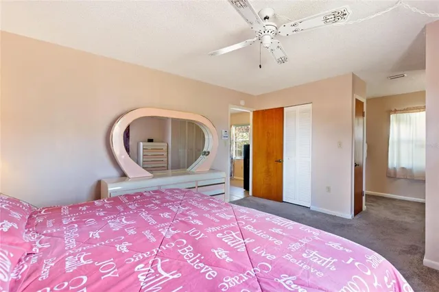 a view of a lake with lawn chairs and a big yard