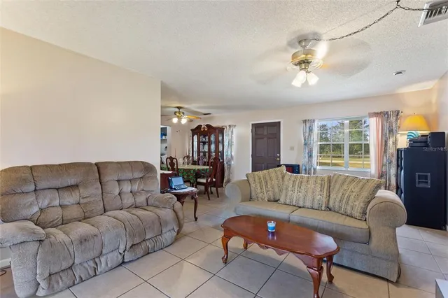 a bedroom with a bed and dresser with mirror