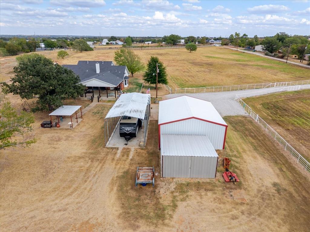 2400 Springfield Road Springtown, TX 76082 - Photo 24 of 31 Workshop, Second covered pavilion on slab, Covered RV carport with plugs, additional storage building for tractor or other implements - what more could you need ?!