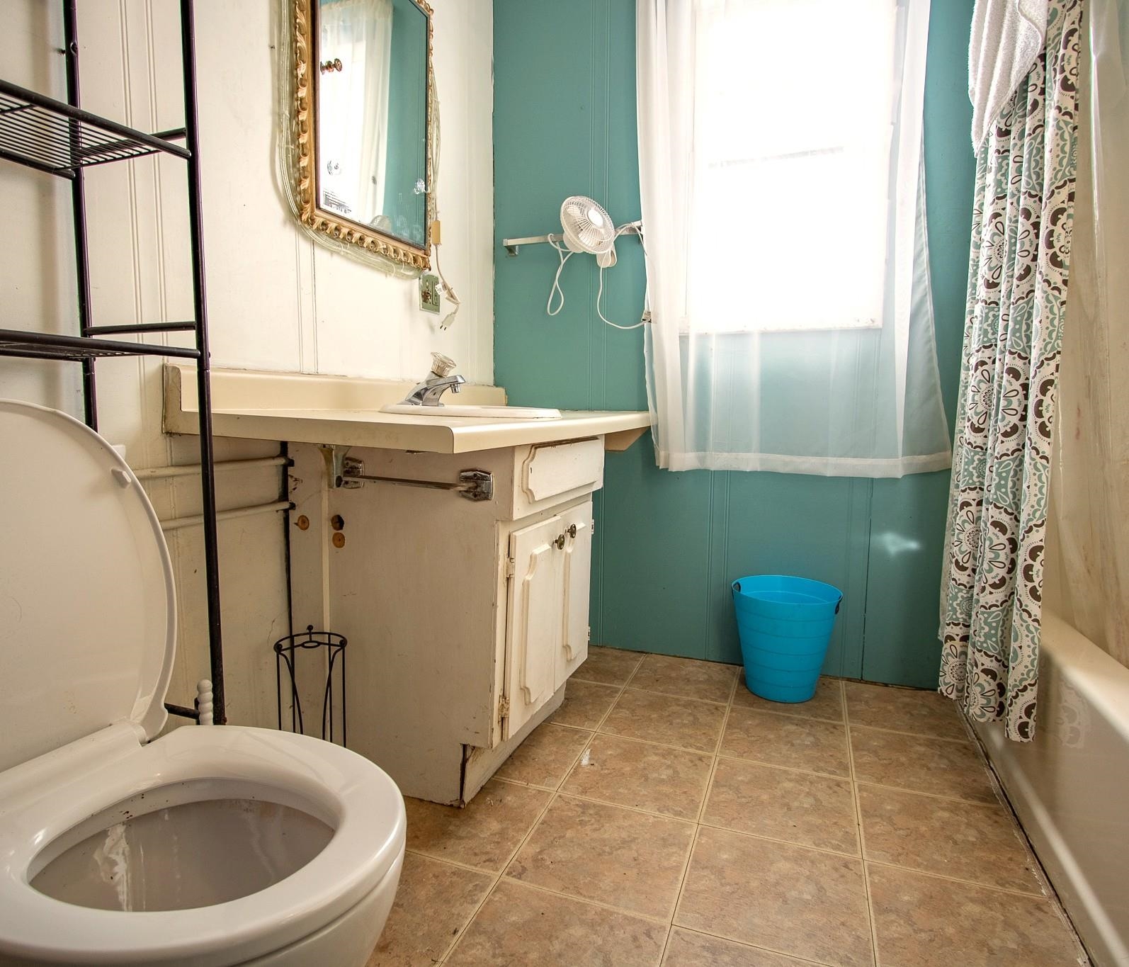 3946 East Calvary Road Duluth, MN 55803 - Photo 10 of 12 Bathroom with shower / bath combo with shower curtain, light tile patterned floors, and vanity