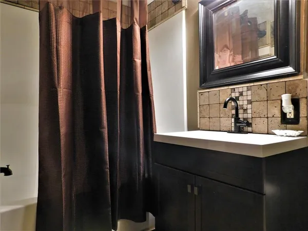 a bathroom with a sink and a mirror