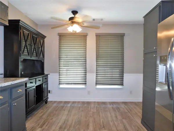 a view of a kitchen and an empty room with a kitchen