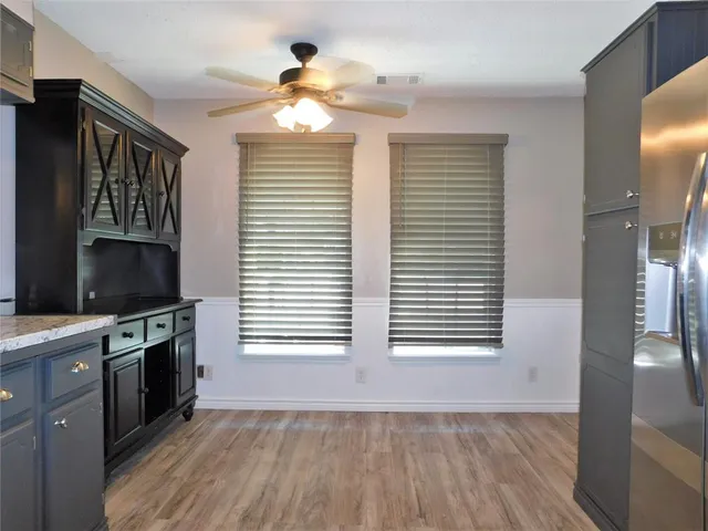 a view of a kitchen and an empty room with a kitchen