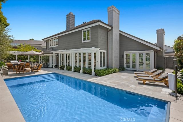 a view of a patio with a table and chairs under an umbrella