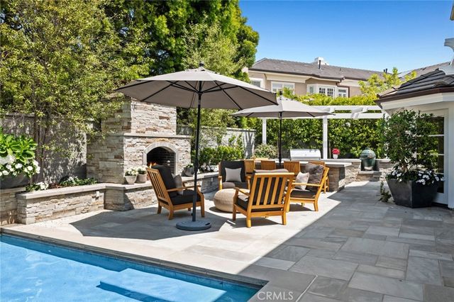 a view of a patio with chairs and a small yard