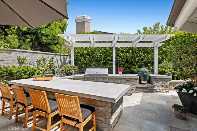 a view of a patio with a table and chairs under an umbrella