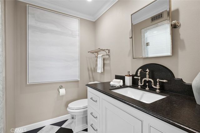 a living room with furniture a rug and white walls