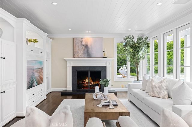 a living room with furniture a fireplace and a table