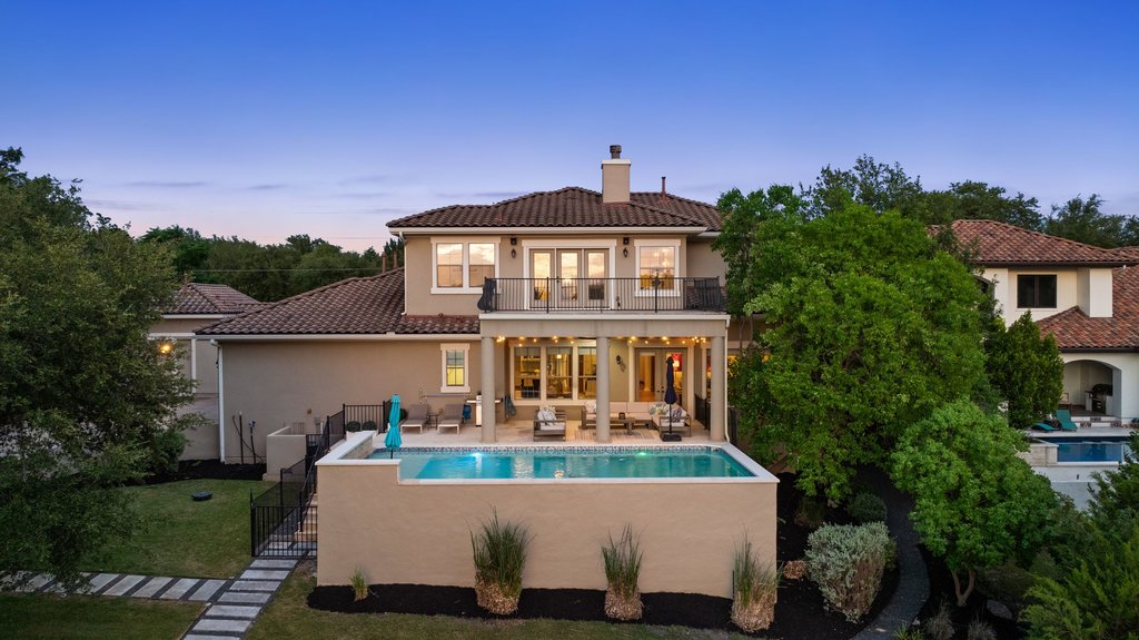 701 Hurst Creek Road Lakeway, TX 78734 - Photo 2 of 37 Back side aerial photo of the 2 outdoor patio areas and the pool.