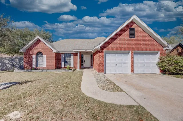 a view of a house with a yard and garage