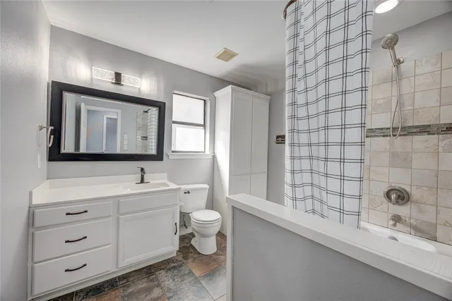 a view of an empty room with wooden floor and closet