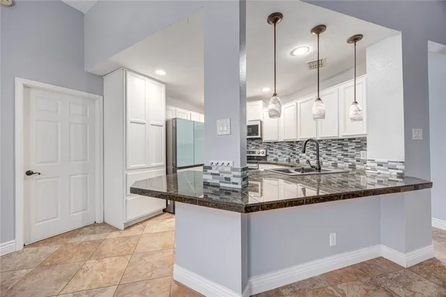 a bathroom with a granite countertop sink a mirror and shower