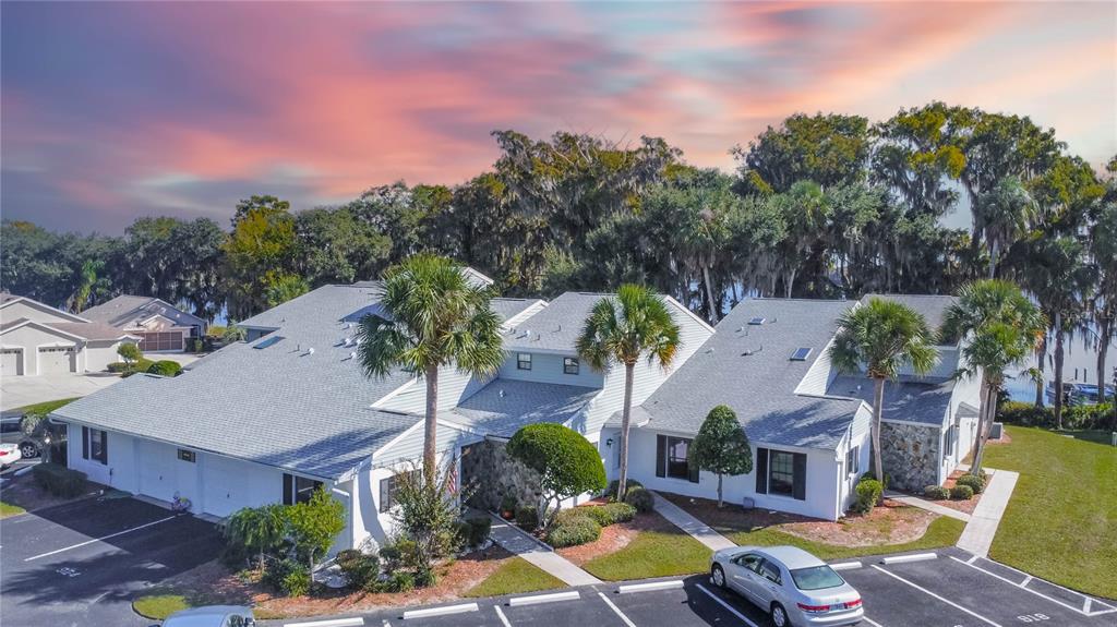 an aerial view of a house with swimming pool and big yard