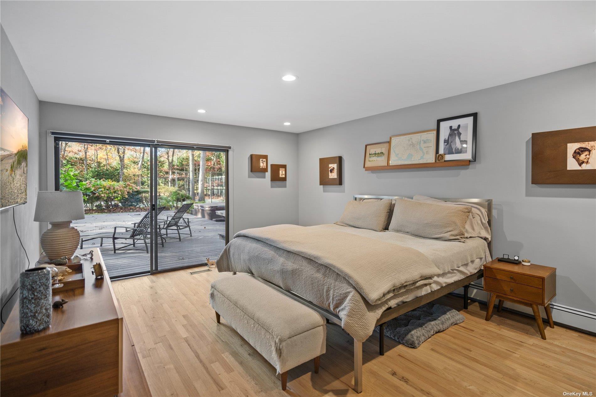 25 North Quarter Road Westhampton, NY 11977 - Photo 16 of 27 a spacious bedroom with a bed and a large window