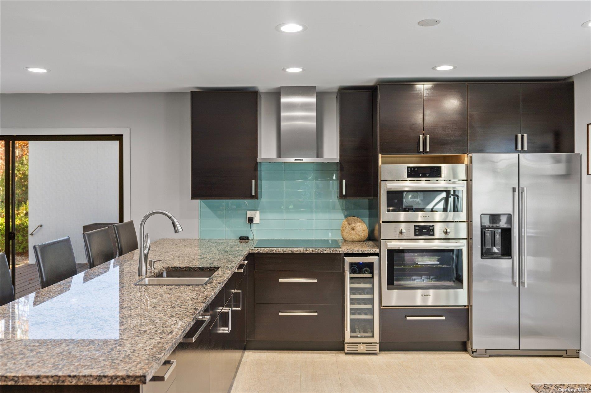25 North Quarter Road Westhampton, NY 11977 - Photo 7 of 27 a kitchen with stainless steel appliances granite countertop a sink and a stove