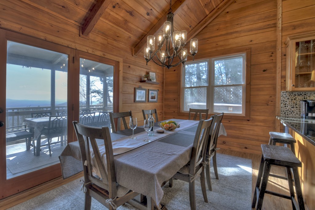 368 Walnut Ridge Ellijay, GA 30536 - Photo 16 of 41 a dining room with furniture a chandelier and wooden floor