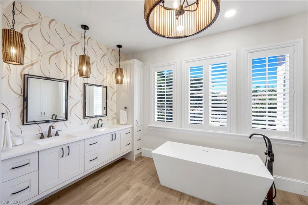 2106 Modena Court Naples, FL 34105 - Photo 26 of 42 a bathroom with a tub sink and mirror