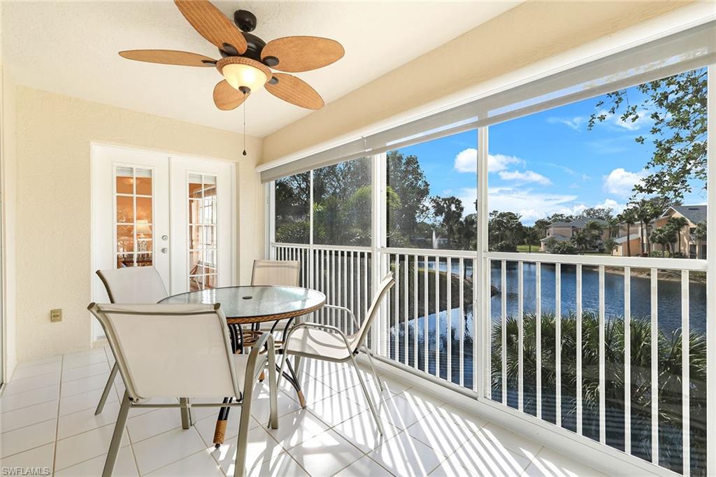 752 Wiggins Lake Drive, Unit 202 Naples, FL 34110 - Photo 19 of 44 Glass-enclosed sunroom opens to the breezes, ideal for indoor-outdoor living year-round