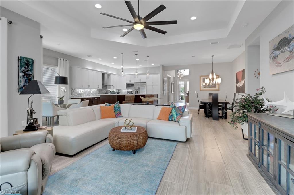 13836 Luna Drive Naples, FL 34109 - Photo 11 of 36 a living room with furniture and a wooden floor