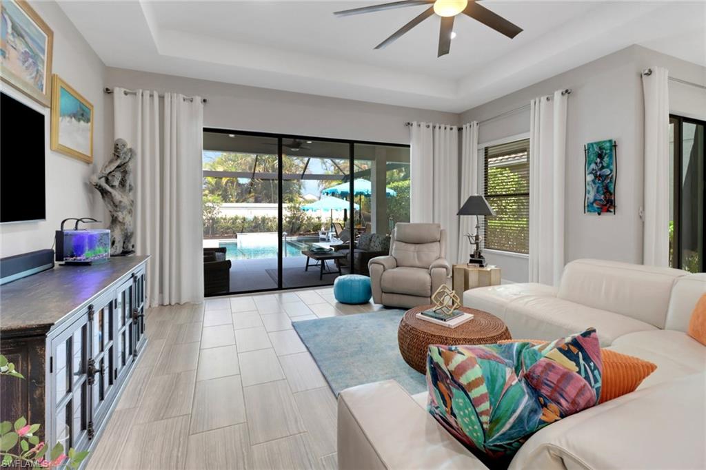 13836 Luna Drive Naples, FL 34109 - Photo 13 of 36 a living room with furniture and a flat screen tv