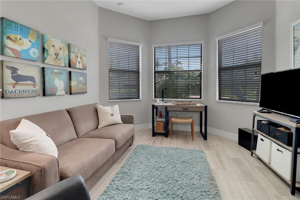 13836 Luna Drive Naples, FL 34109 - Photo 15 of 36 a living room with furniture and a flat screen tv