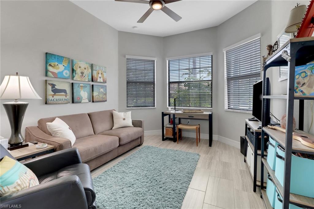13836 Luna Drive Naples, FL 34109 - Photo 16 of 36 a living room with furniture and a flat screen tv