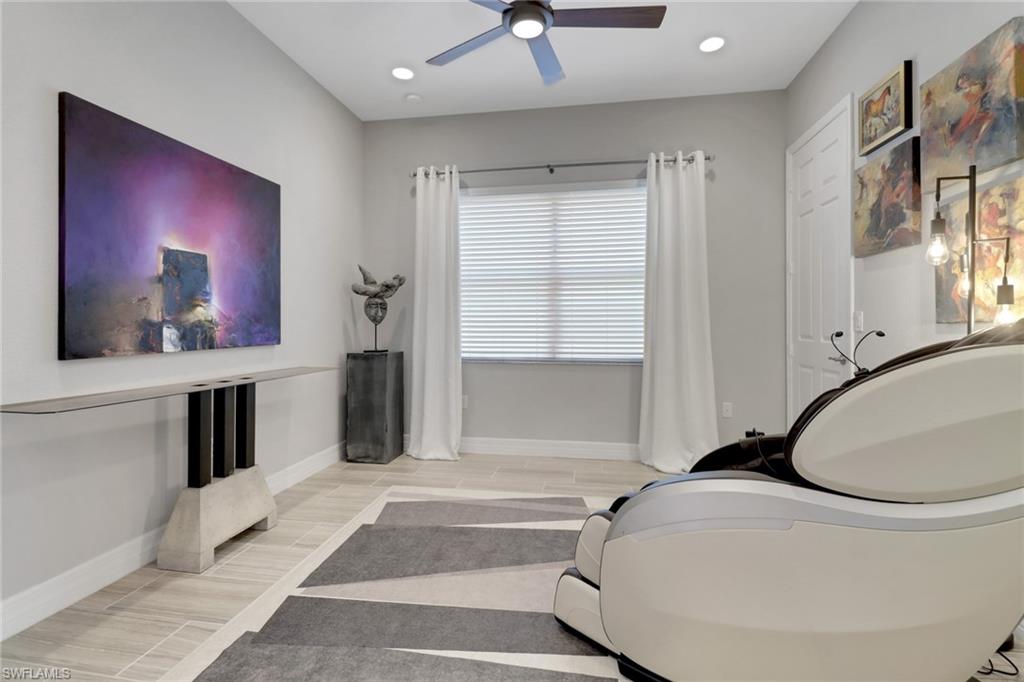 13836 Luna Drive Naples, FL 34109 - Photo 17 of 36 a living room with a couch and a potted plant