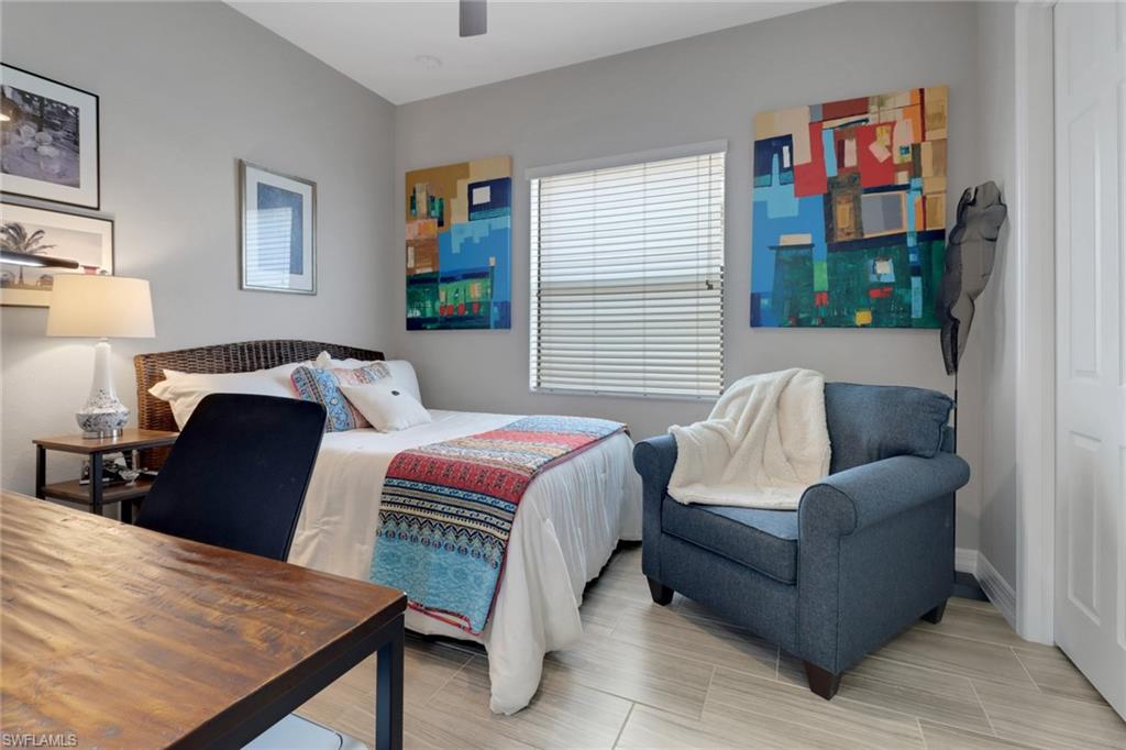 13836 Luna Drive Naples, FL 34109 - Photo 20 of 36 a bedroom with a bed and wooden floor