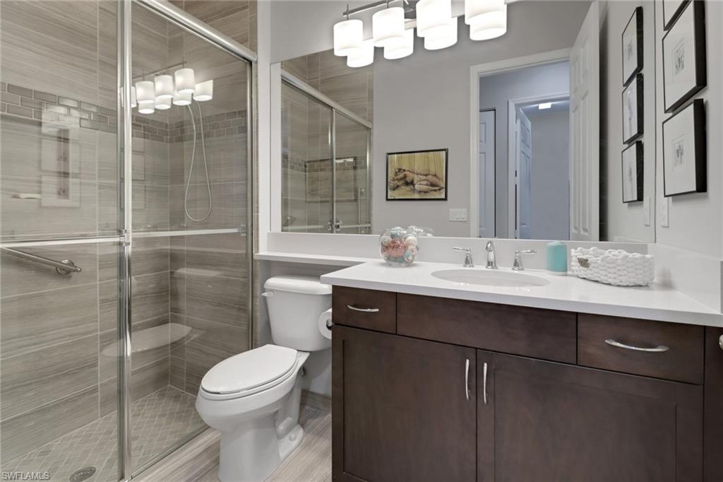 13836 Luna Drive Naples, FL 34109 - Photo 21 of 36 a bathroom with a sink toilet and shower