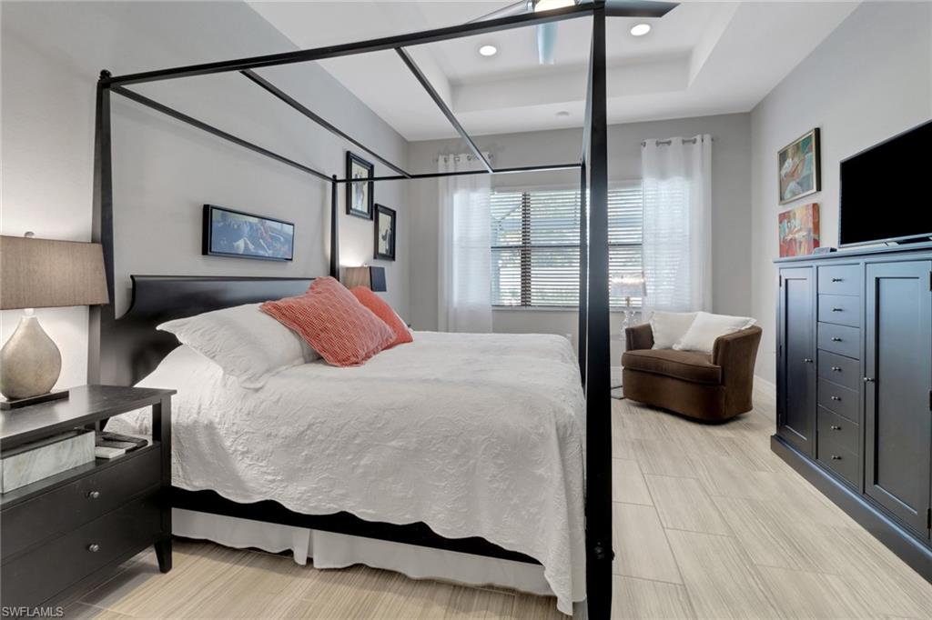 13836 Luna Drive Naples, FL 34109 - Photo 22 of 36 a bedroom with a bed and a flat screen tv