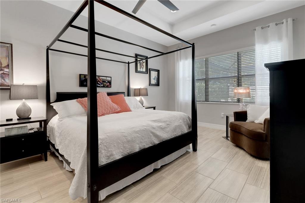 13836 Luna Drive Naples, FL 34109 - Photo 24 of 36 a bedroom with a bed window and a flat screen tv