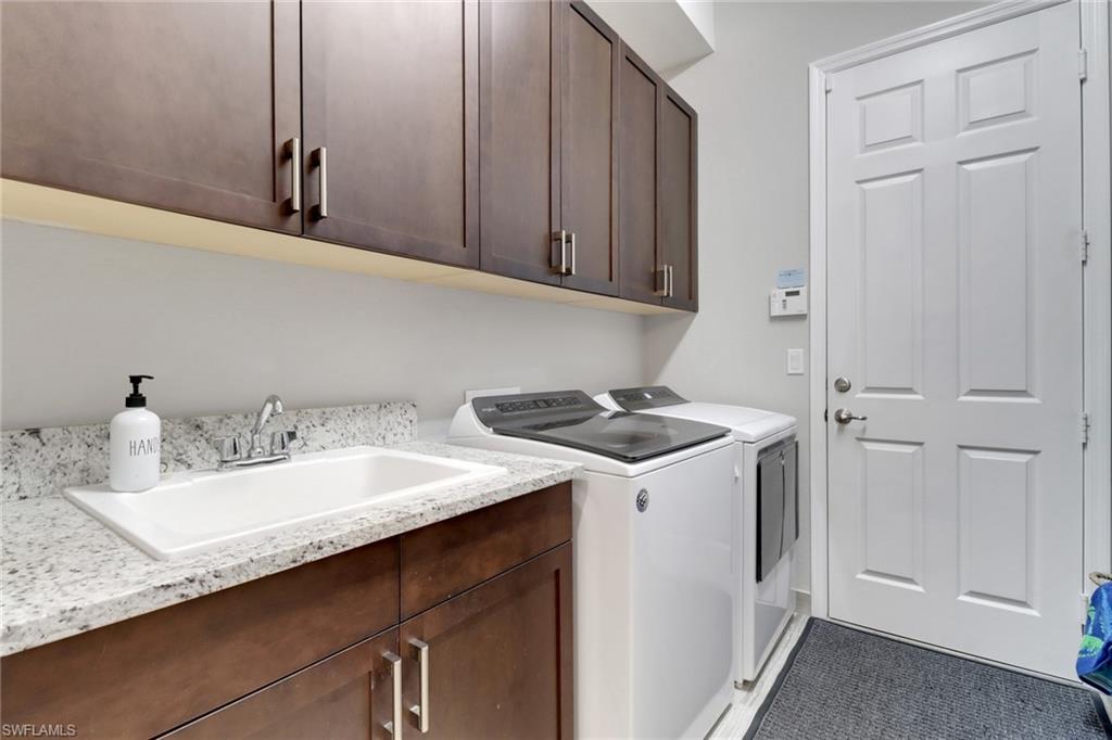 13836 Luna Drive Naples, FL 34109 - Photo 28 of 36 a kitchen with a sink and cabinets