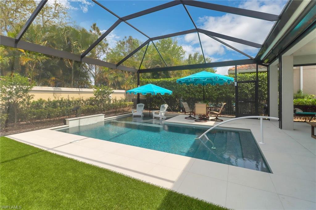 13836 Luna Drive Naples, FL 34109 - Photo 30 of 36 a view of a swimming pool with a patio