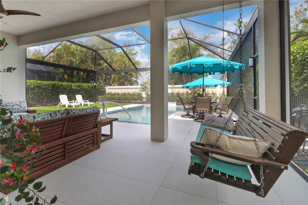 13836 Luna Drive Naples, FL 34109 - Photo 34 of 36 a outdoor space with the couches and dining table with the garden view