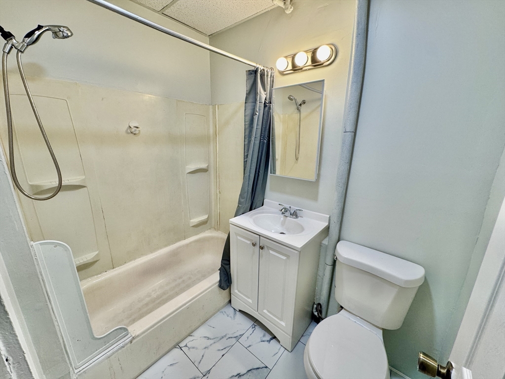 28 Randall Place Springfield, MA 01108 - Photo 11 of 22 a bathroom with a sink a toilet and shower