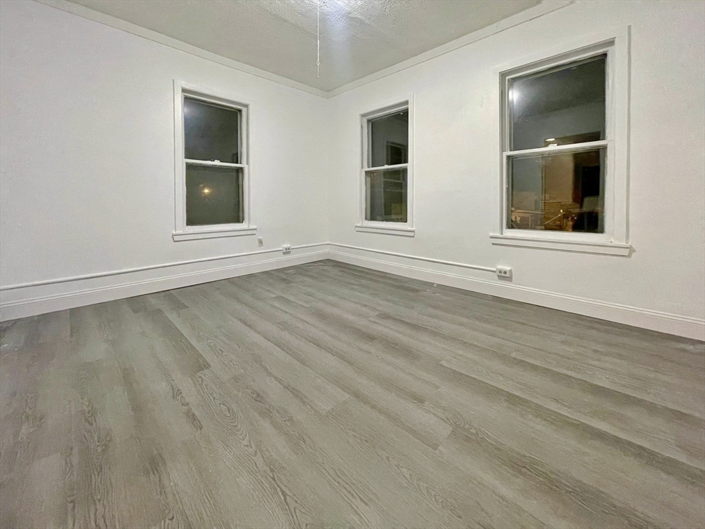 28 Randall Place Springfield, MA 01108 - Photo 20 of 22 a view of an empty room with wooden floor and windows