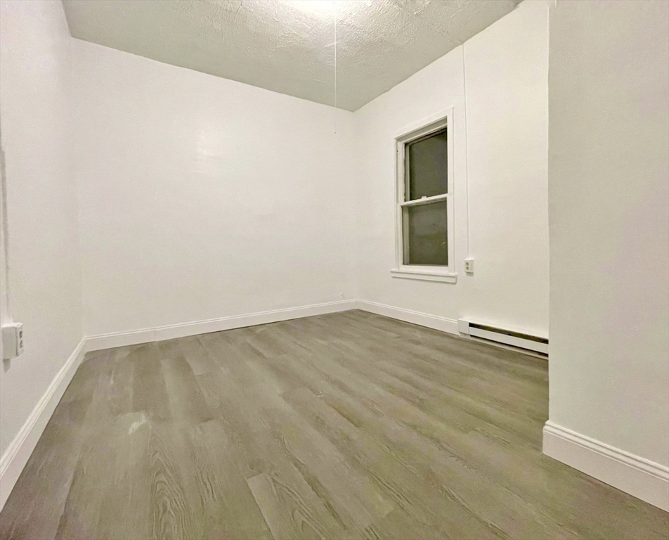 28 Randall Place Springfield, MA 01108 - Photo 21 of 22 an empty room with wooden floor and windows