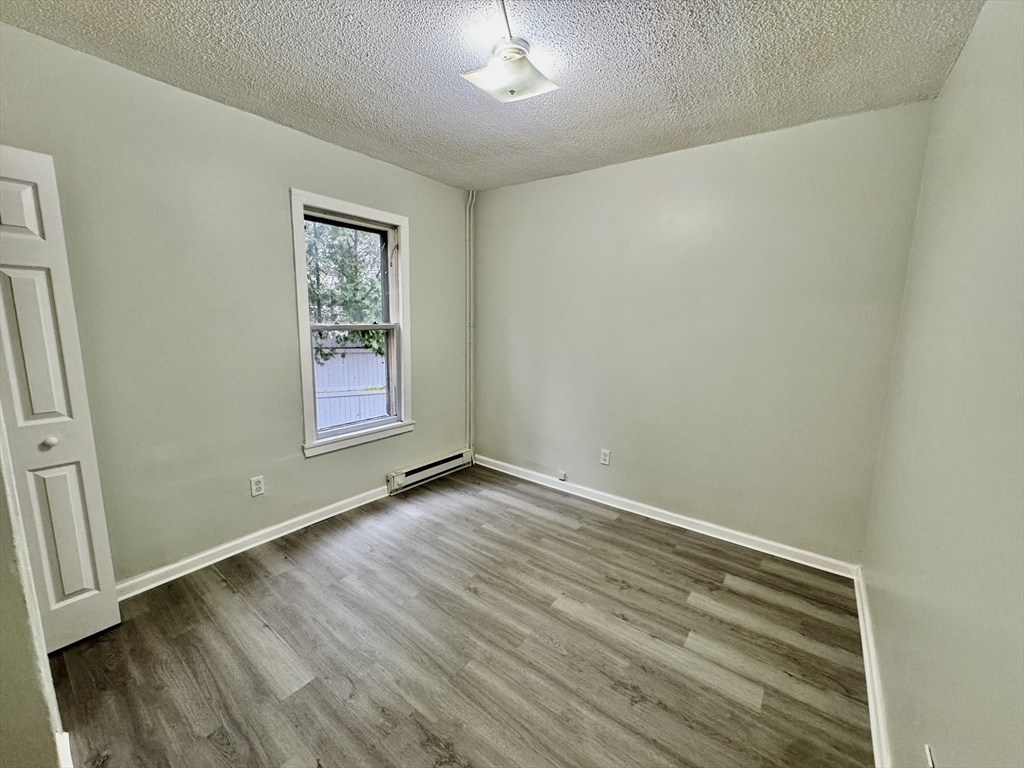 28 Randall Place Springfield, MA 01108 - Photo 8 of 22 an empty room with wooden floor and windows