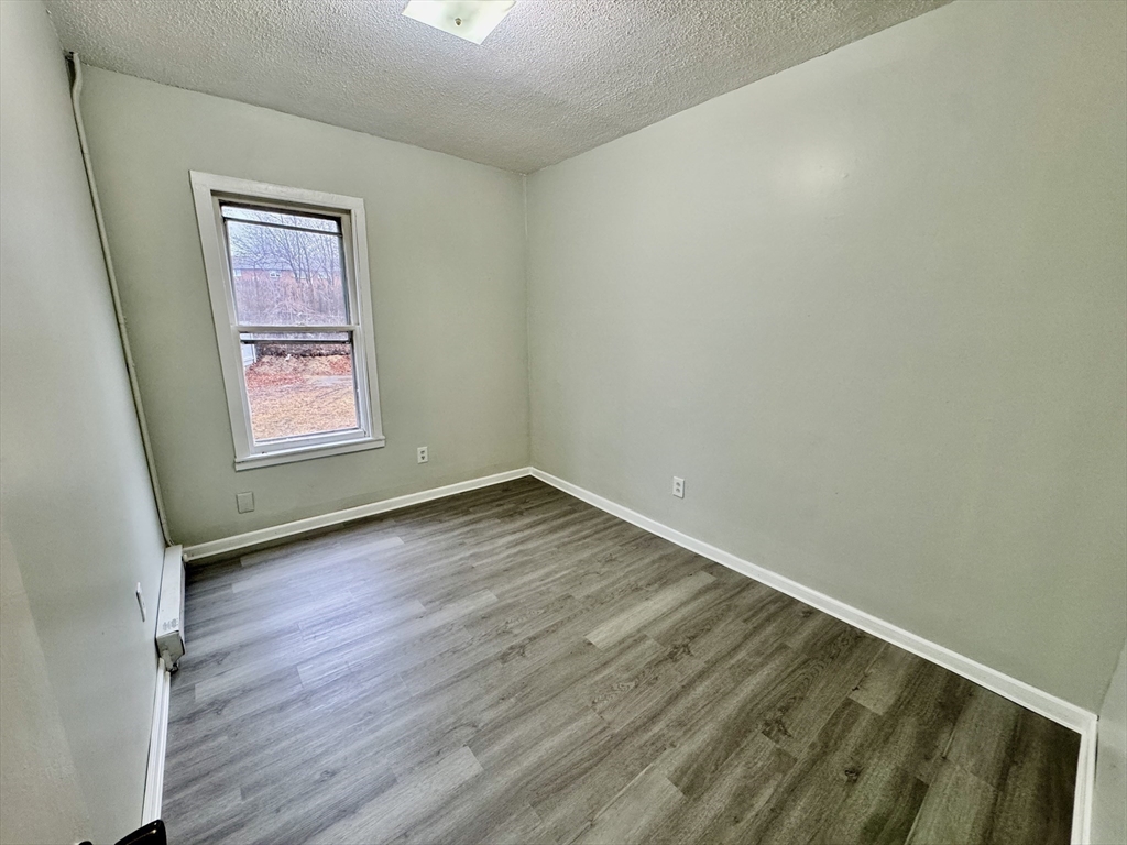 28 Randall Place Springfield, MA 01108 - Photo 9 of 22 an empty room with wooden floor and windows